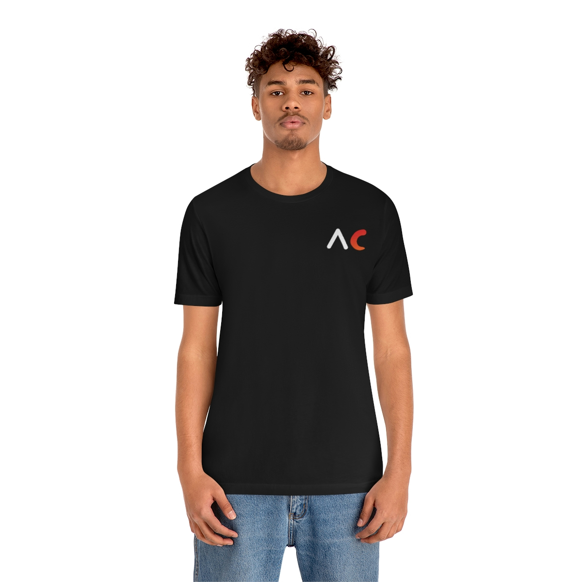 A young medium skin tone male model wearing a black t-shirt with stylized "AC" over the left breast denoting sickle cell trait status.