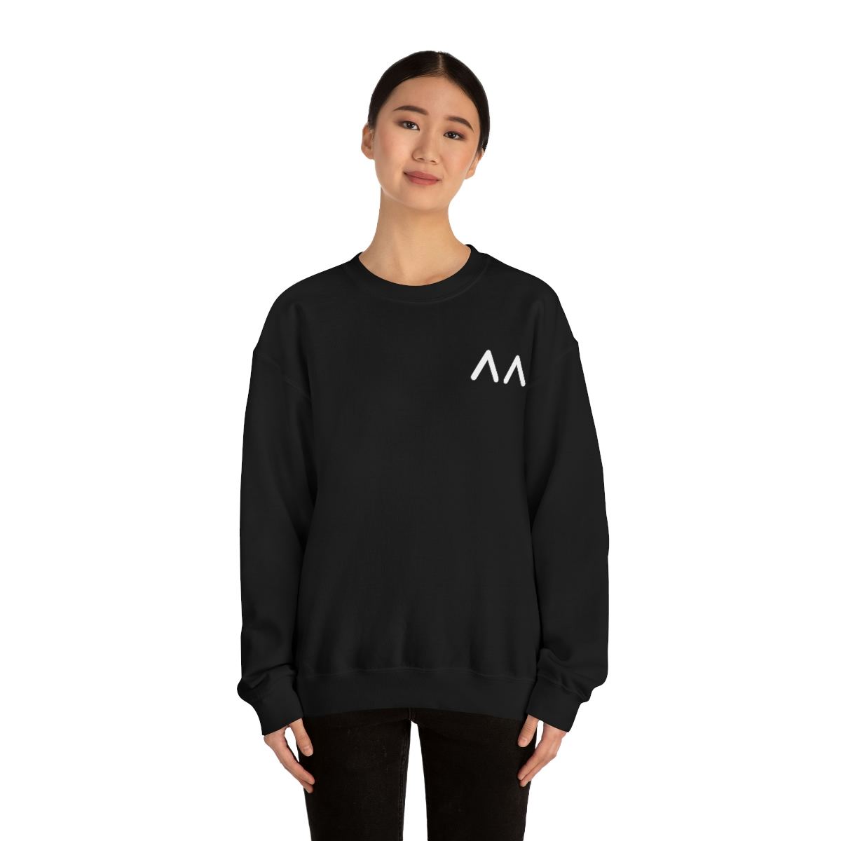 A young light skin tone female model wearing a black sweatshirt with stylized "AA" over the left breast denoting sickle cell trait status.