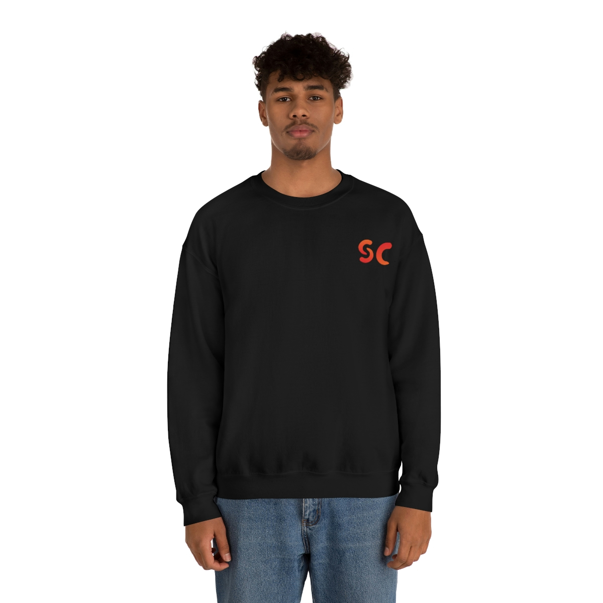 A young medium skin tone male model wearing a black sweatshirt with stylized "SC" over the left breast denoting sickle cell trait status.